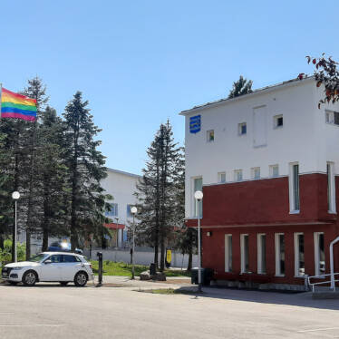 Kommunhuset i solsken sommardag med regnbågsflaggen hissad i flaggstången.